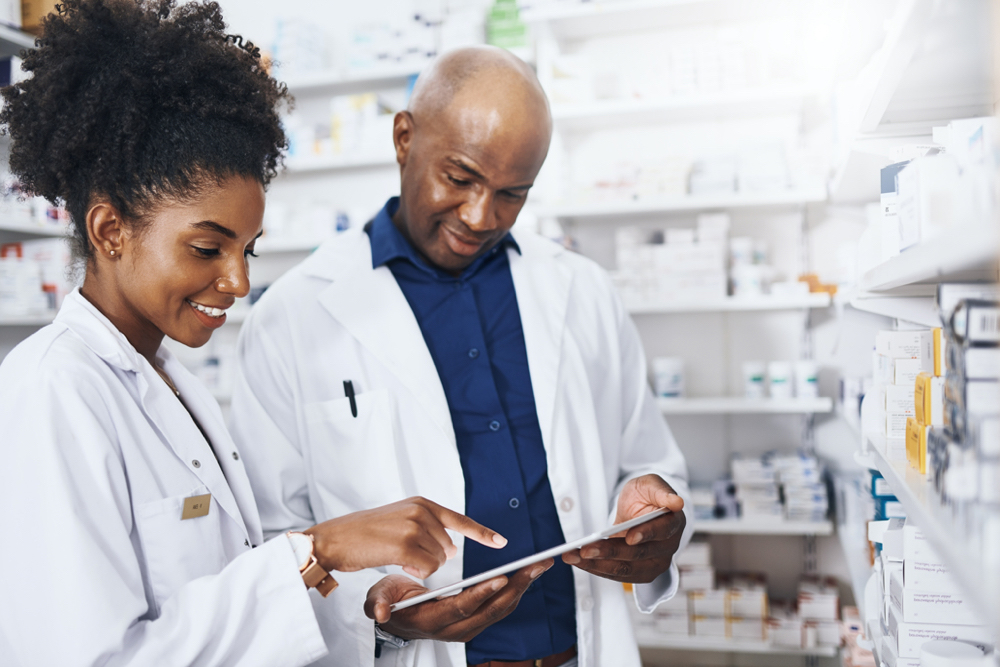 two pharmacists working on an ipad