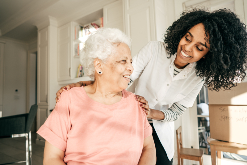 pharmacist smiling at senior woman