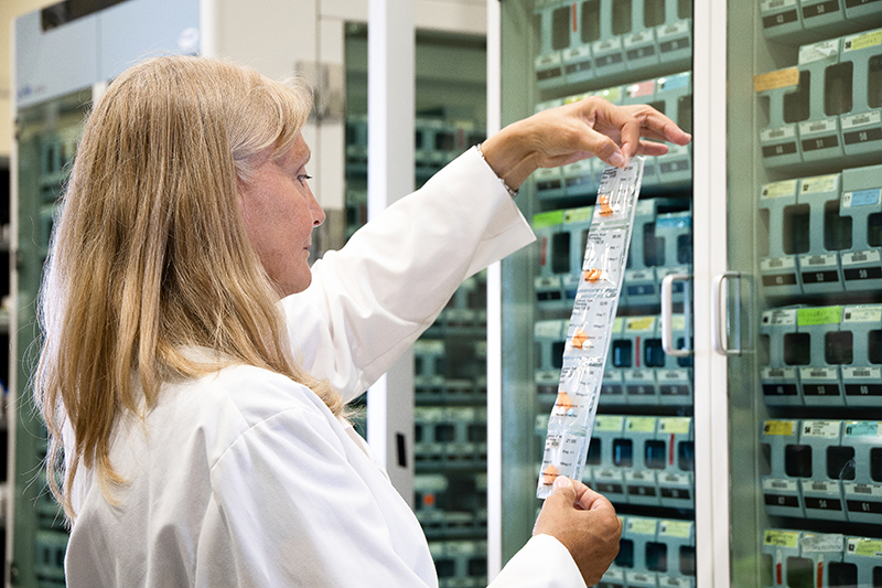 A female pharmacist examining a medication strip